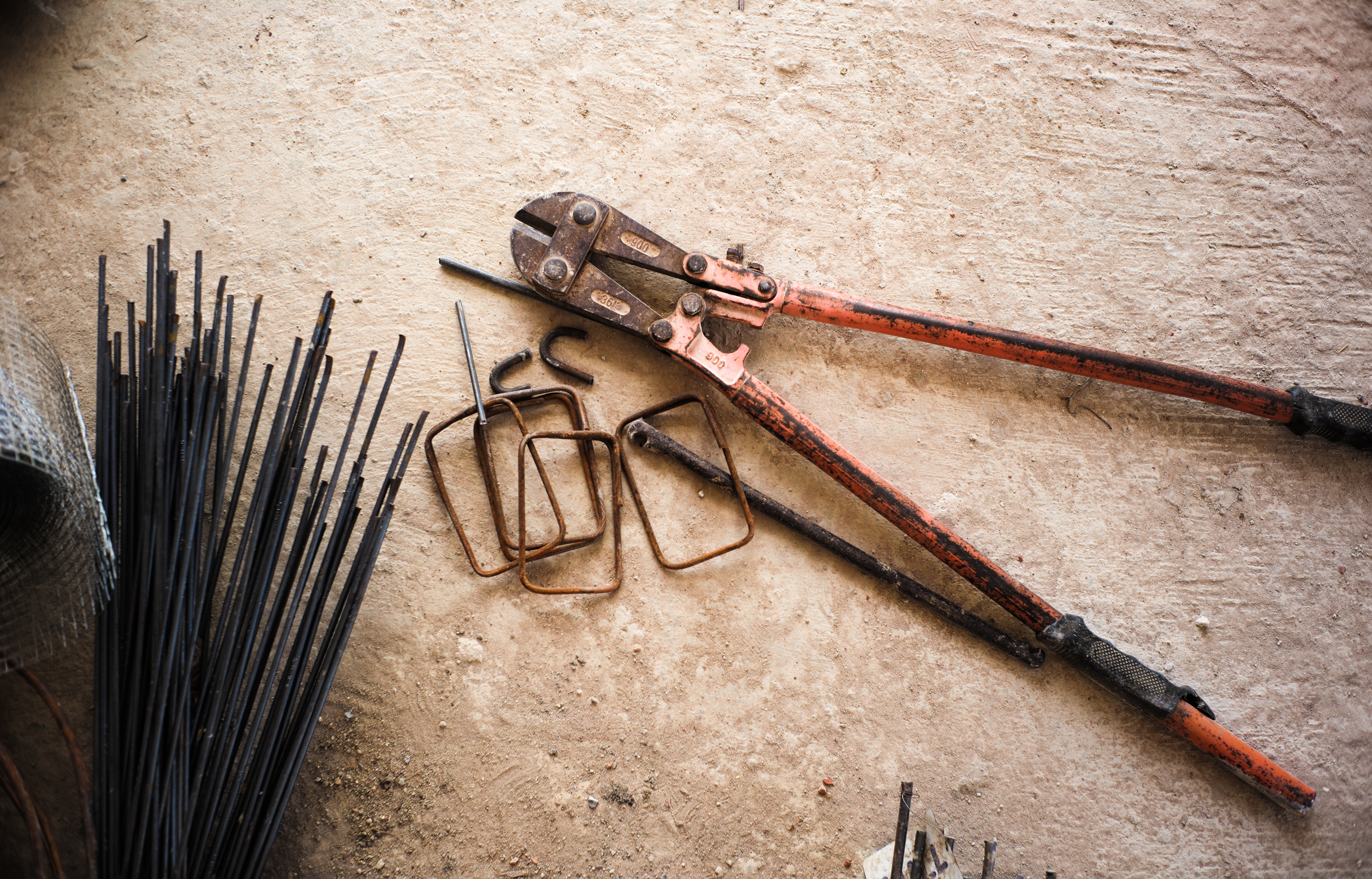 Steel wire cutter and reinforcement steel on the concrete floor at the construction site
